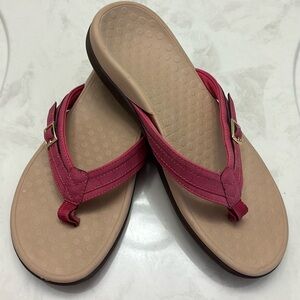 Vionic suede thong sandal with gold buckle hardware.